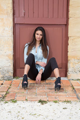 Beautiful girl sitting on a warm sunny day with high heels