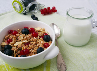 Healthy breakfast muesli with blueberry and red currant and milk with blueberry and raspberry