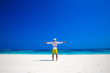 Fototapeta na wymiar Nature. Seashore. Happy free Man Raising His Hands or Open arms