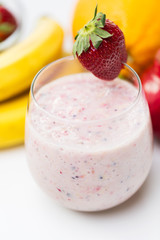 close up of glass with milk shake and fruits