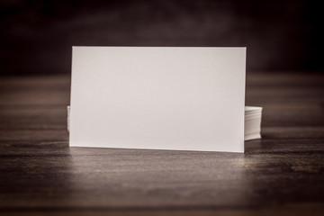 Blank business (visit) card on old wooden. Toned photo.