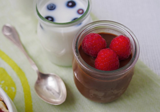 Healthy breakfast chocolate mousse with raspberry and milk with blueberry