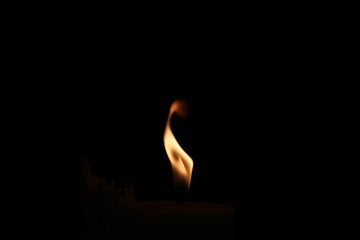 A small flame in the darkness.