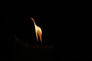 A small flame in the darkness.