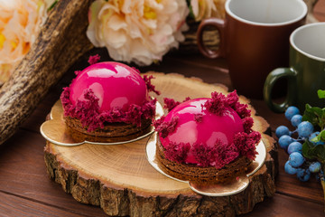 Obraz na płótnie Canvas French pastry with pink glaze and burgundy sponge cake