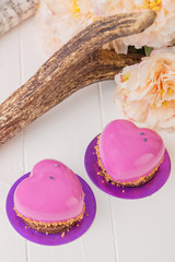Obraz na płótnie Canvas Heart shaped french pastry with pink glaze
