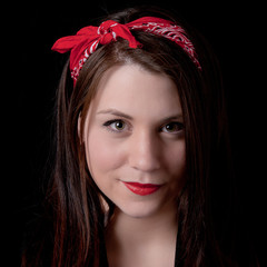 Portrait of a beautiful young woman wearing a red bandana in her hair.
