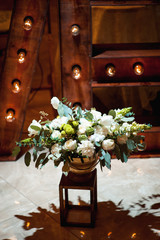 basket of spring flowers on a wooden chair