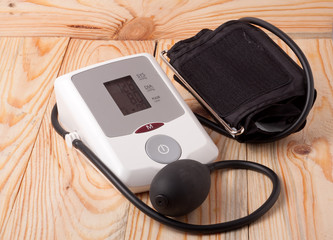 automatic blood pressure monitor on a wooden background
