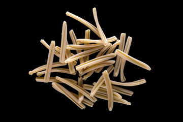 Italian pasta on a black background. Food image in low key with a place for an inscription. black isolation