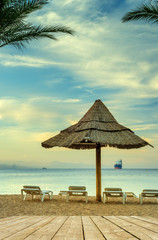 Relaxing facilities on the golden beach of Eilat - famous tourist, resort and recreation city in Israel