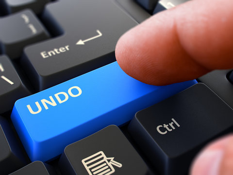 Undo - Written on Blue Keyboard Key. Male Hand Presses Button on Black PC Keyboard. Closeup View. Blurred Background. 3D Render.