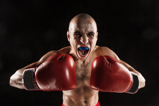 The Young Man Kickboxing On Black  With Kapa In Mouth