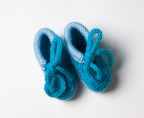 blue baby's bootees on white