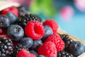 Berries closeup background with raspberries, blueberries and blackberries
