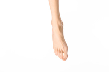 Pedicure and foot care topic: the naked man's legs isolated on white background in studio