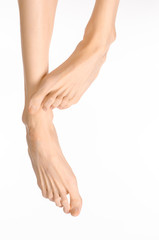 Pedicure and foot care topic: the naked man's legs isolated on white background in studio