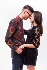 Hipster couple. Beautiful young loving couple posing while standing against white background.