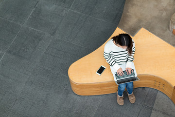 Top view of woman working on laptop computer