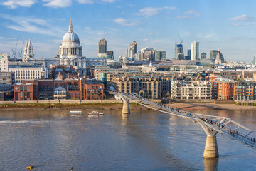 Millennium Bridge across Thames River and St. Paul's Cathedral in  London