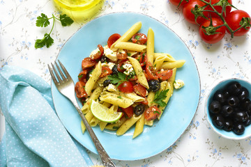 Pasta salad with cherry tomatoes,olives and feta cheese.