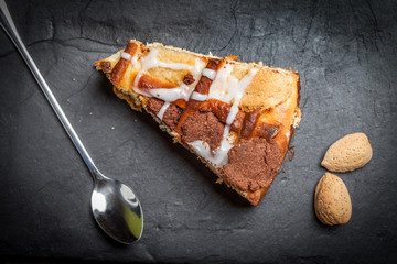 Cheesecake with raisins on a slate plate.