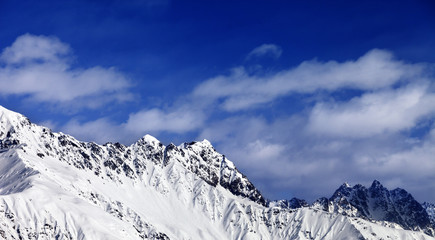 Panoramic view on snowy mountains at sun day