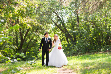 Romantic wedding couple having fun together outdoor in nature