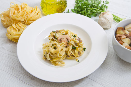 dish with tagliatelle and mushrooms and fresh ingredients