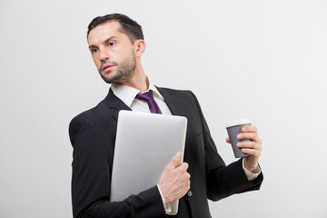 Young business man with a laptop and coffee