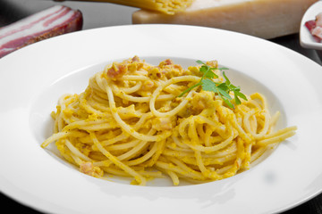 dish with carbonara's spaghetti and ingredients