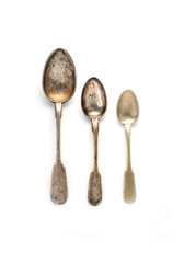 Vintage three spoons of different sizes on a white background