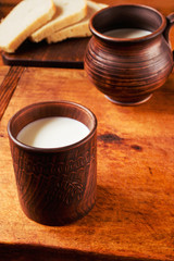 Fresh milk in a clay mug with bread for a lazy breakfast