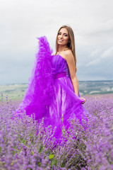 Beautiful woman is wearing fashion dress at lavender