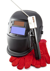 Protective welder mask, electrode and gloves on a white background
