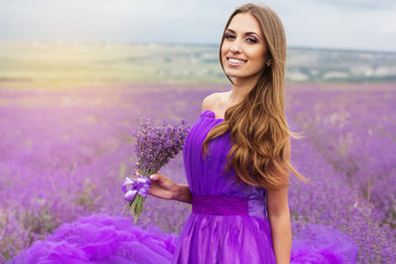Smiling girl with bouquet of lavender flowers