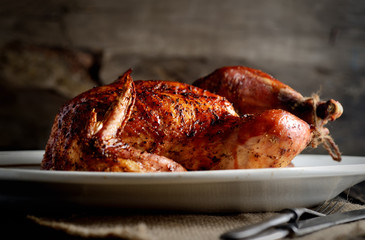 grilled chicken on a oval dish on a wooden background
