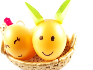 Plastic easter eggs, decorated light green rabbit ears with drawing happy face with smiling in handmade basket