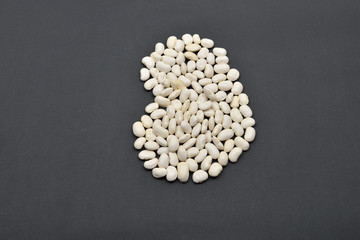 Large bean made from white beans on black background. Food vegan