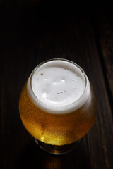 beer in a glass on a wooden background