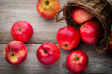 Ripe red apples on wooden background.