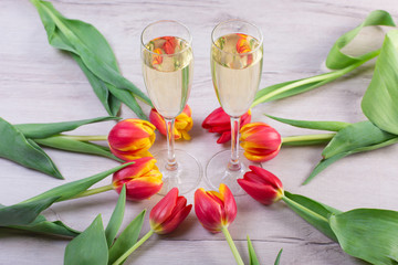 photo of two champagnes glasses and bottle on white wooden table with copy space.