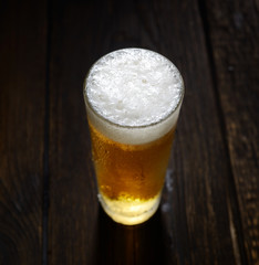 beer in a glass on a wooden background