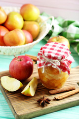 Apple jam in jar on a mint wooden table