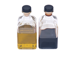 Extra virgin oil and balsamic vinegar separated on white background