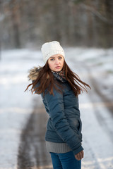 Young woman on a walk in snowy winter