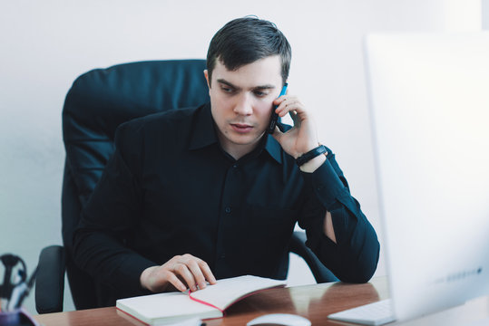 available for business men in black shirt working at desk computer