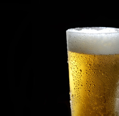 beer in a glass on a black background