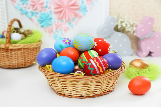 Colorful Easter eggs on white table indoors