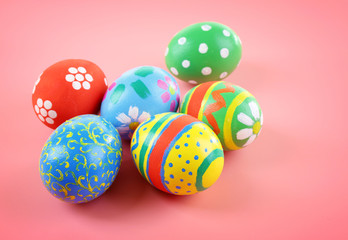 Fototapeta na wymiar Multicoloured Easter eggs on pink background